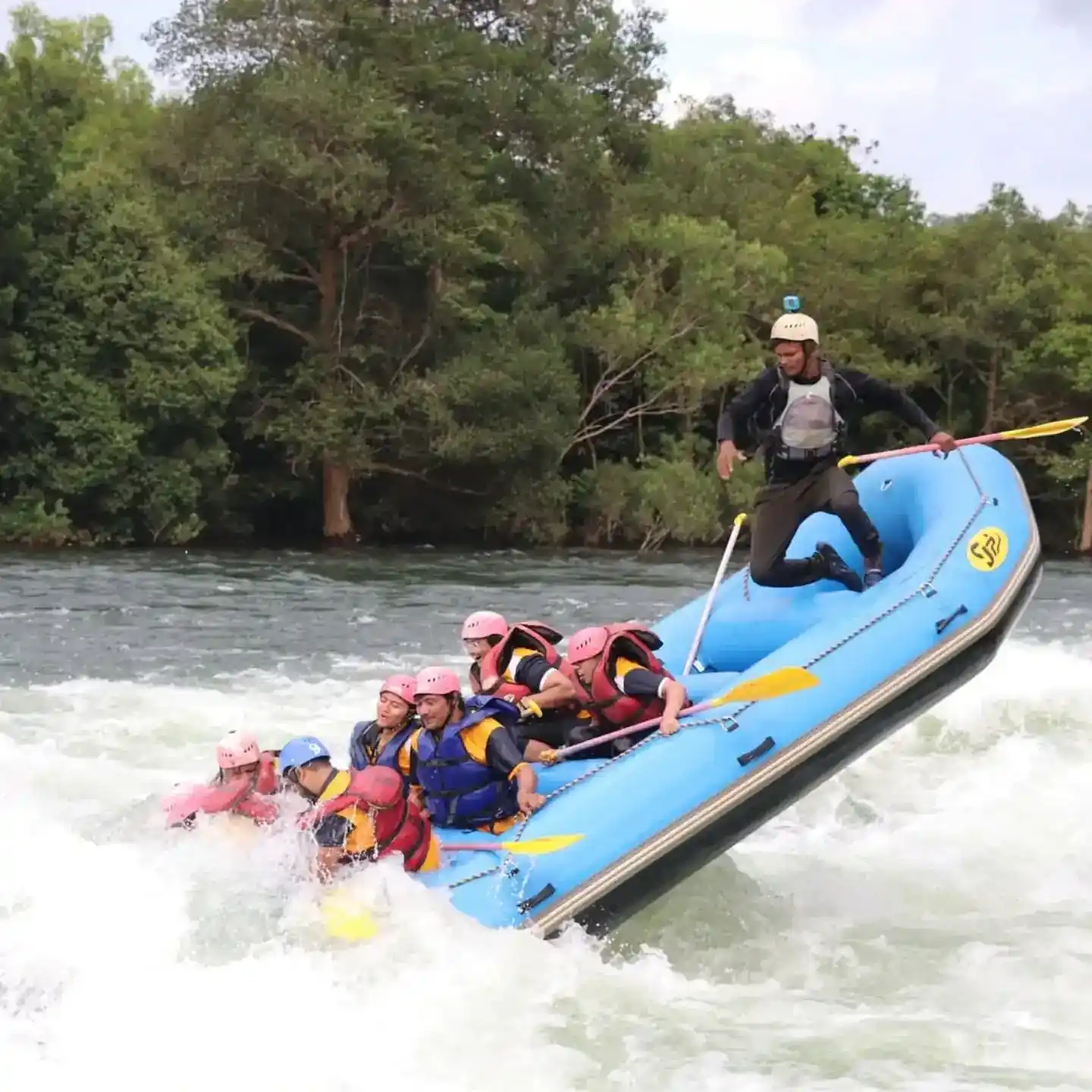 White water rafting group navigating rapids on Kali River in Dandeli with guide