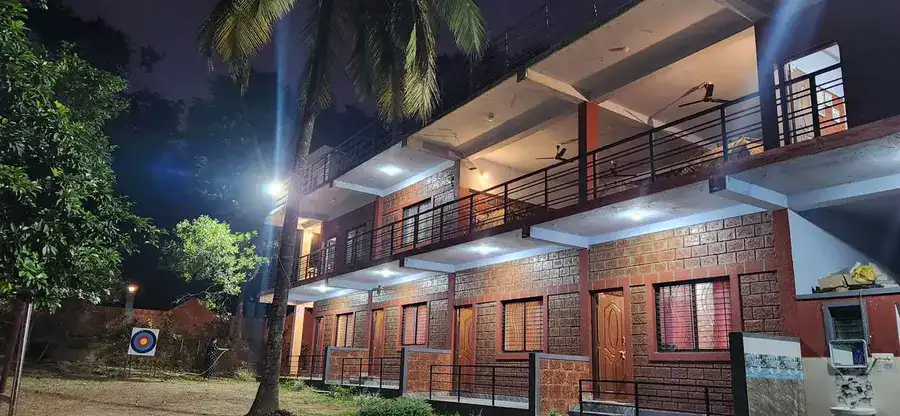 Beautiful night view of Tusker Trails Resort illuminated amidst jungle surroundings