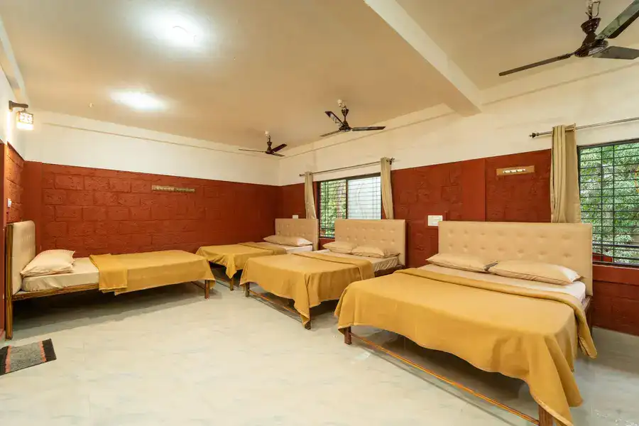 Non-AC 10-sharing dormitory room for budget travelers at Tusker Trails